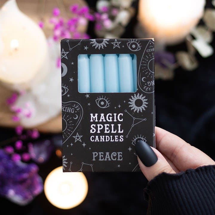 Set of 12 light blue peace spell candles in a window picture box