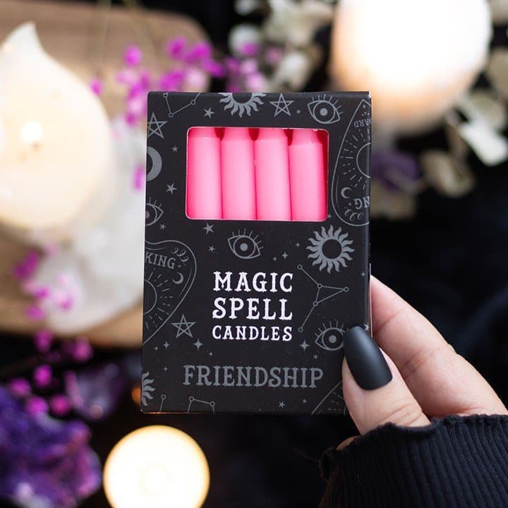 Set of 12 pink friendship spell candles in a window picture box