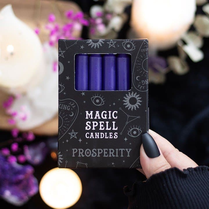 Set of 12 purple prosperity spell candles in a window picture box