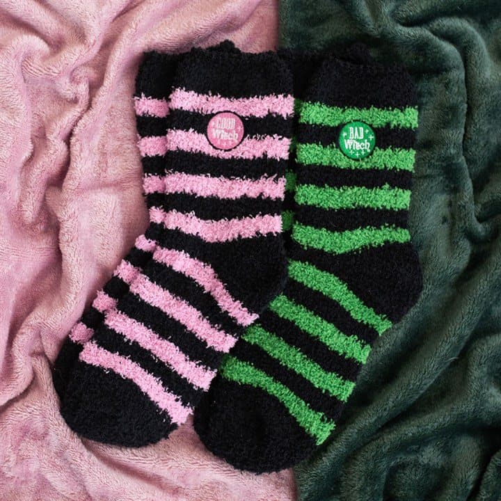 Set of two fluffy socks with Good Witch and Bad Witch designs in striped colours