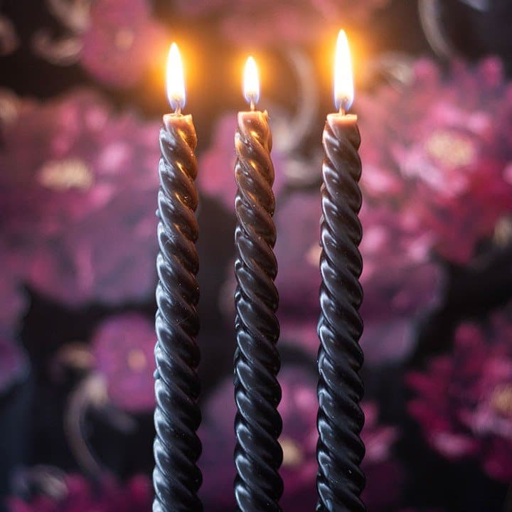 Set of three black twisted taper candles in a window box