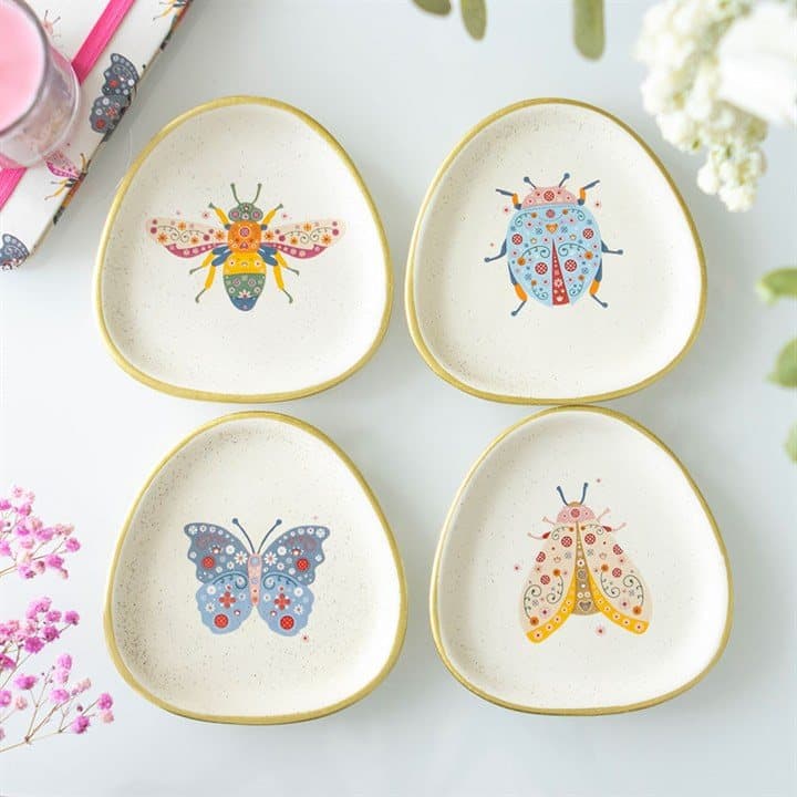 Set of four speckled ceramic trinket dishes with floral bug designs and gold edging