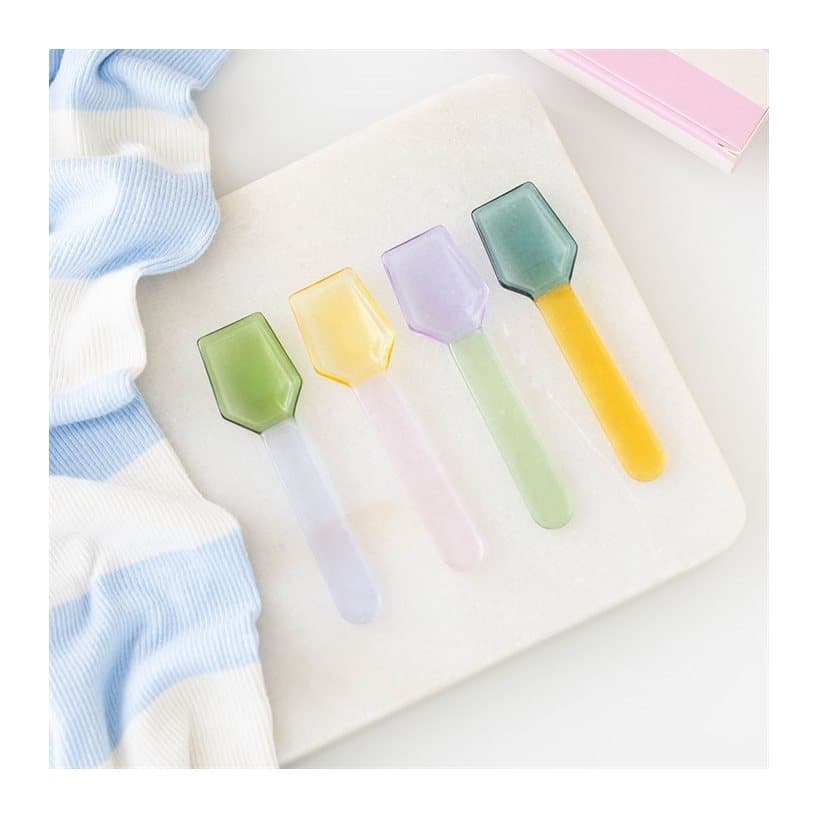Set of four pastel glass dessert spoons in a box with a window