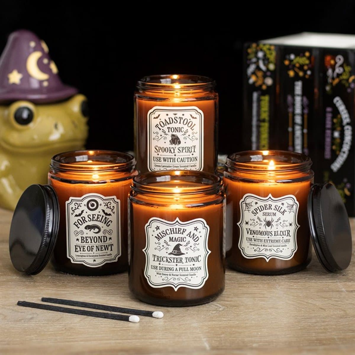 Set of four witch's apothecary amber jar candles with potion labels