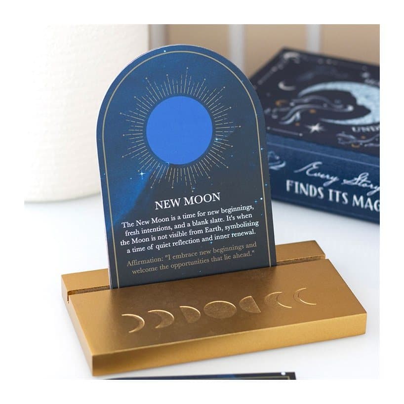 Eight illustrated moon phase cards and a wooden display stand