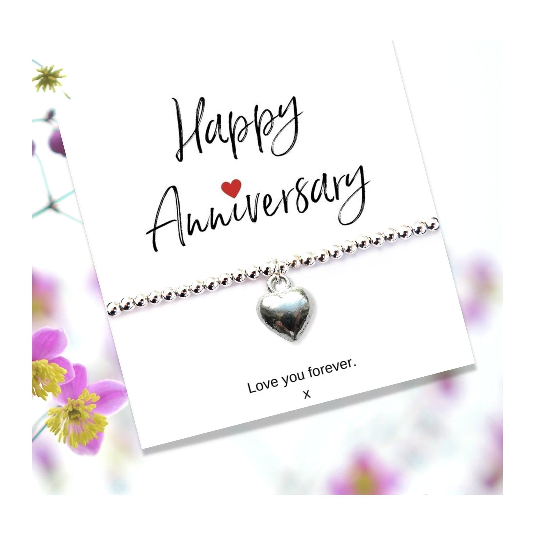 Silver heart beaded bracelet on an anniversary message card