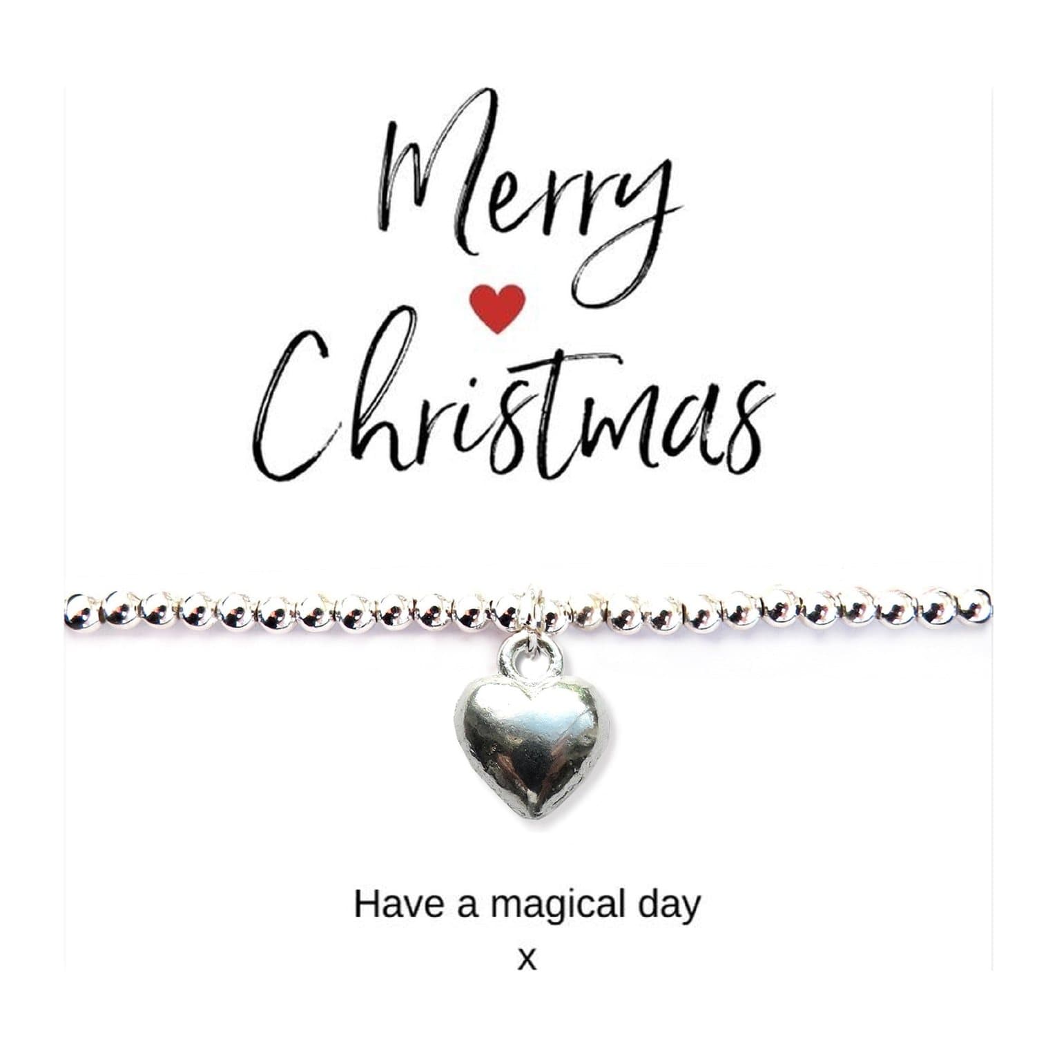 Silver puff heart charm stretch bracelet on a Merry Christmas card
