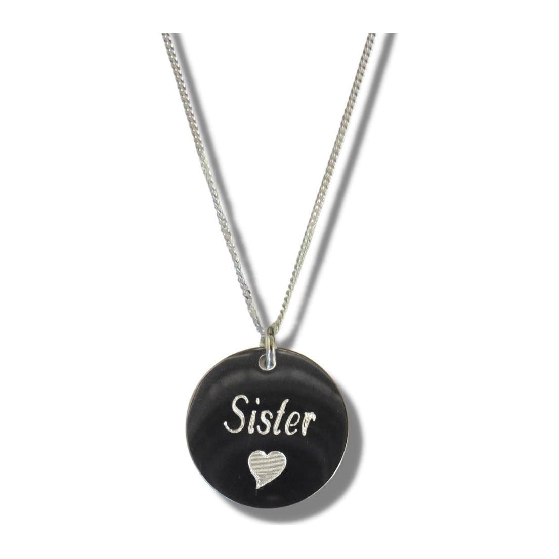 Silver necklace with a disc engraved with the word Sister and a small heart symbol