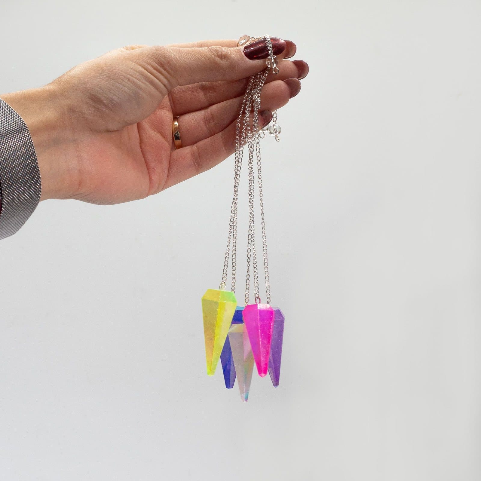Pale green six sided aurora crystal pendulum with a chain and small bead