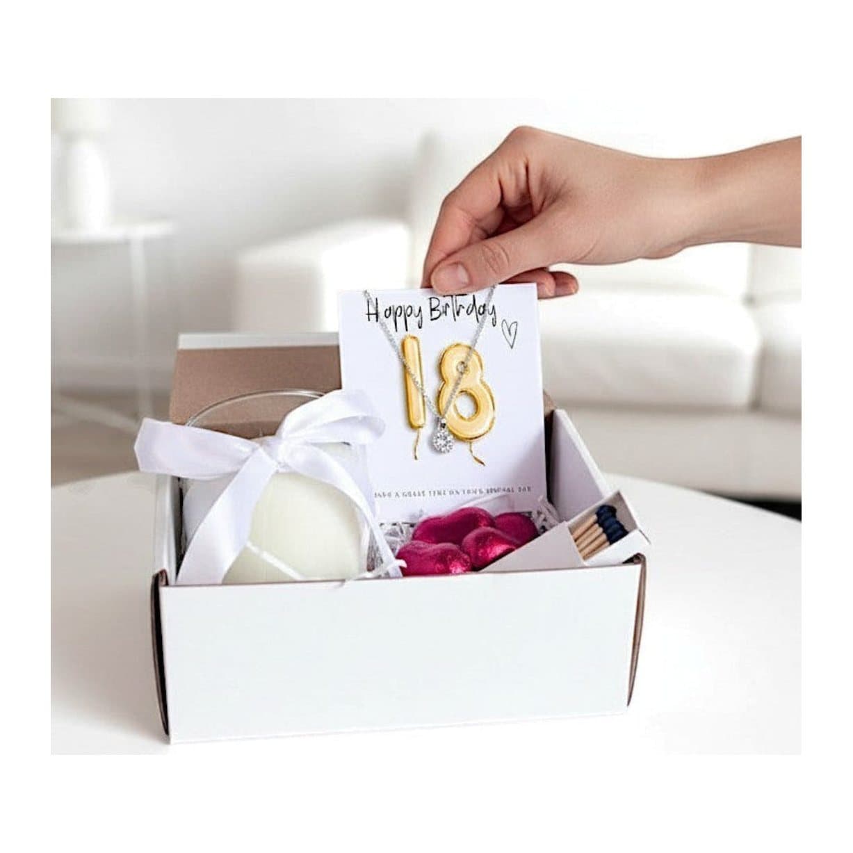 Small 18th birthday gold balloon gift hamper with a necklace, candle and chocolates