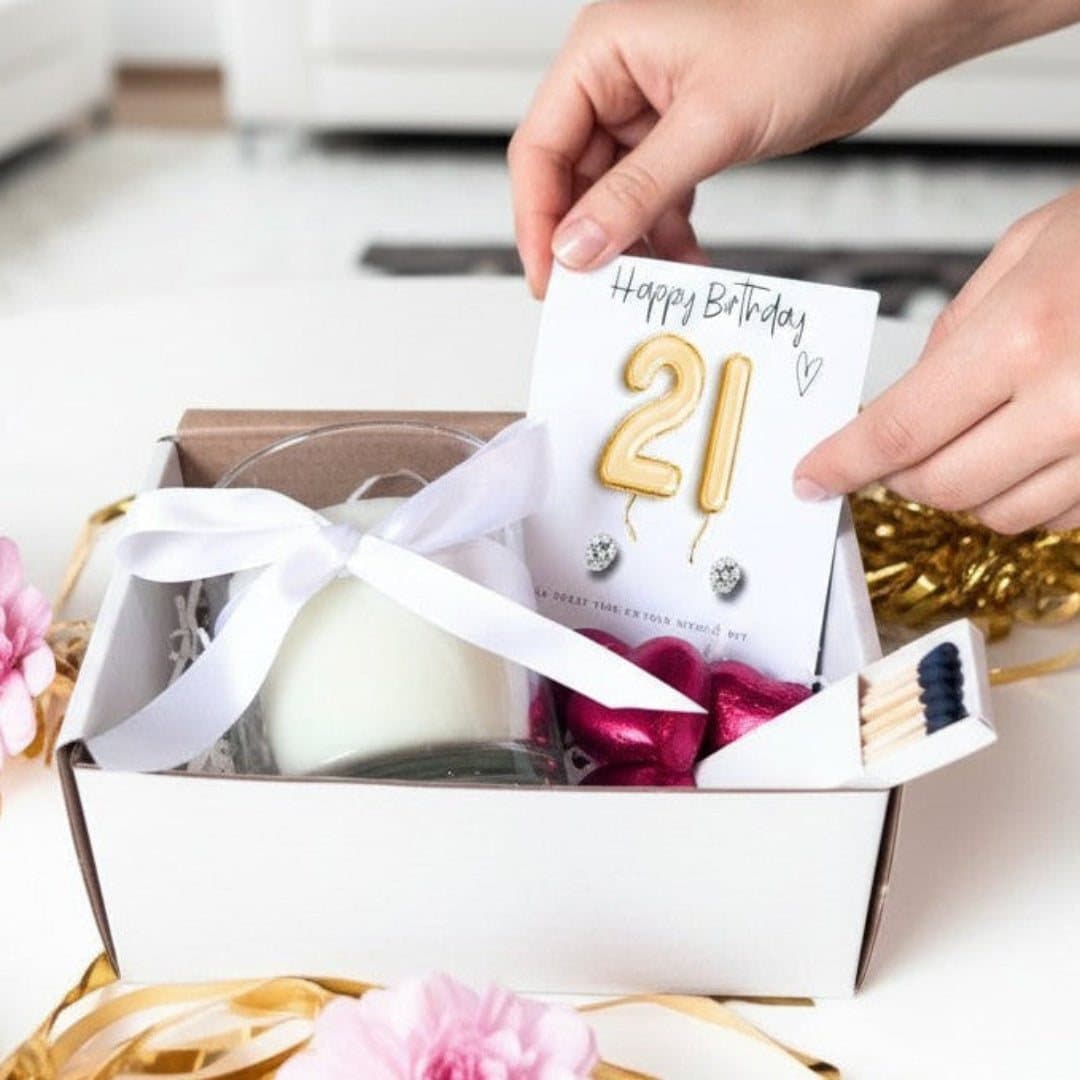 21st birthday hamper with gold balloons, candle, earrings and chocolates