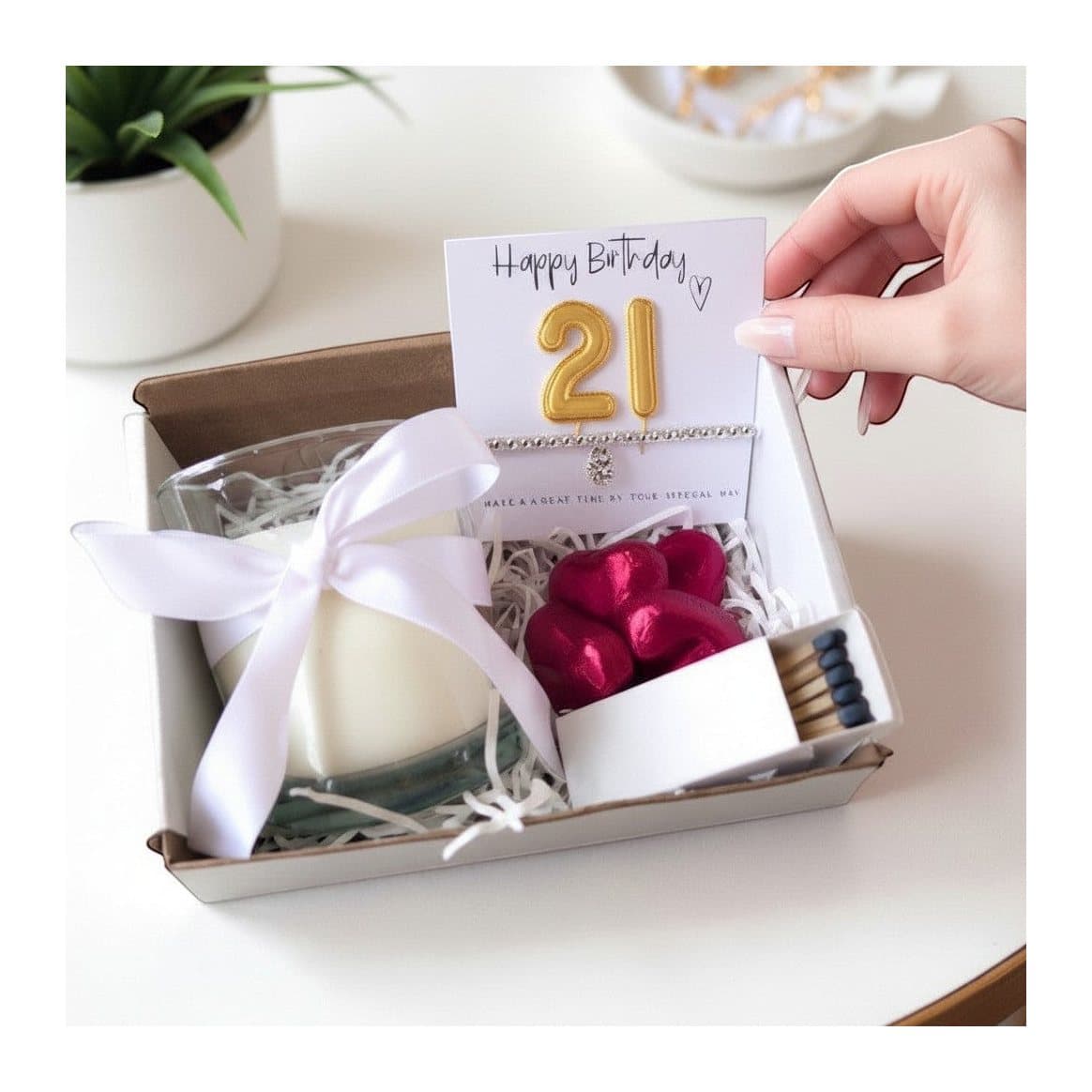 Small 21st birthday hamper with a silver bracelet, vanilla candle and chocolate hearts