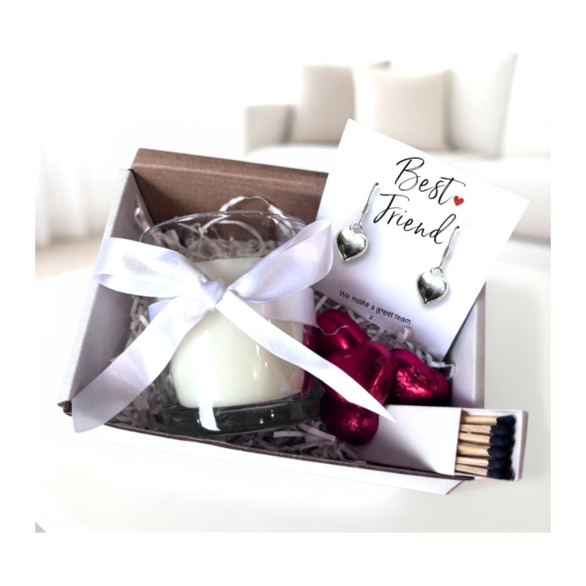 Gift hamper with silver heart earrings, a vanilla candle and four chocolate hearts