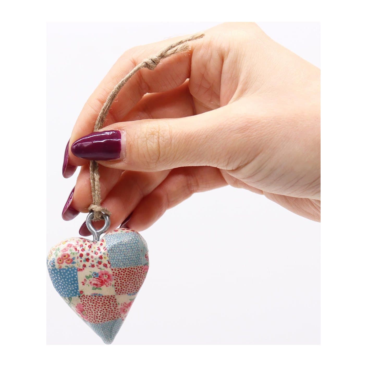 Two small wooden heart decorations with a blue and red cheque pattern