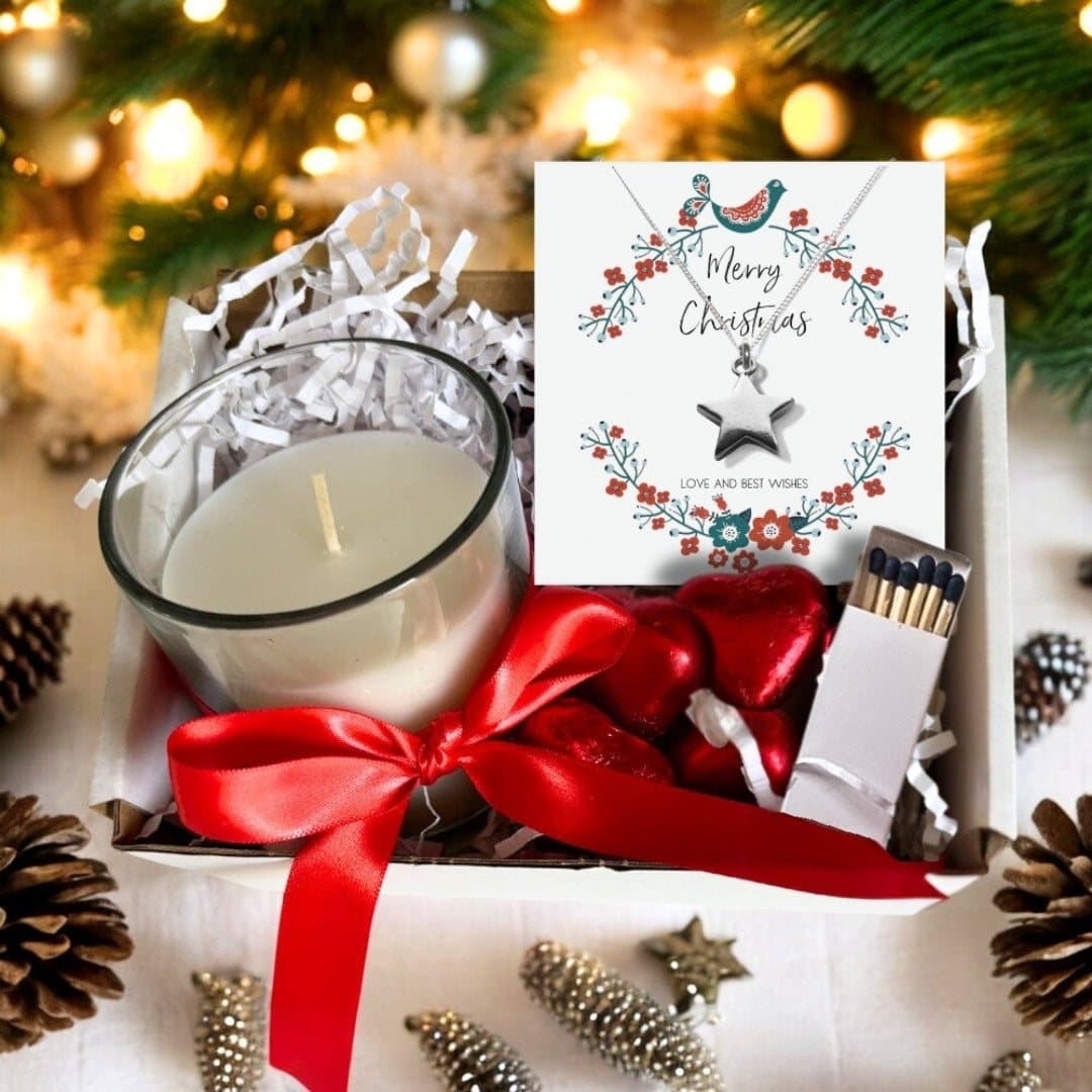 Christmas hamper with a silver star necklace, vanilla candle and chocolate hearts