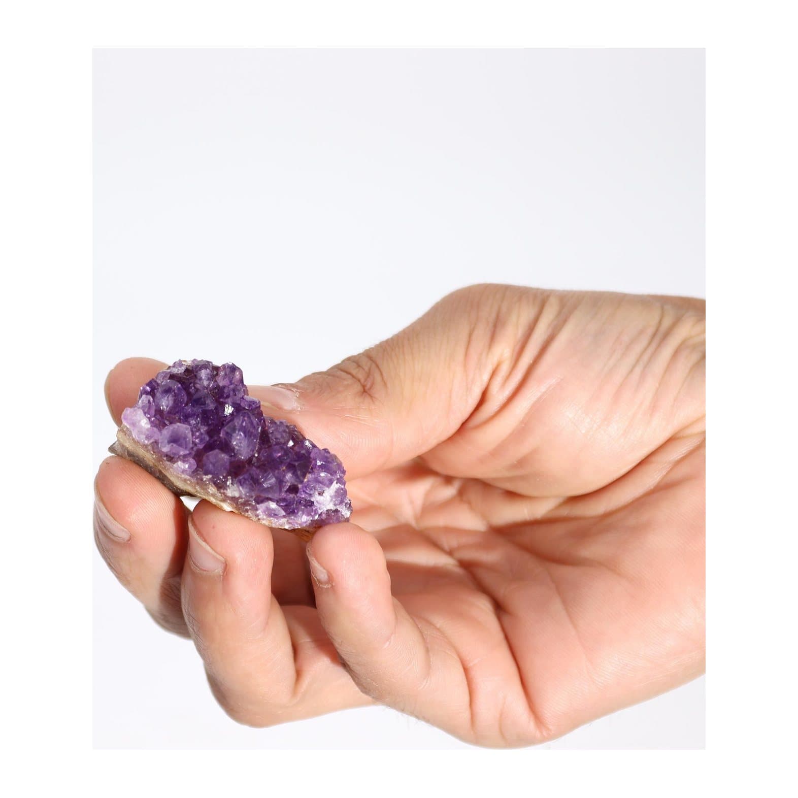 Small natural amethyst cluster with purple crystal points