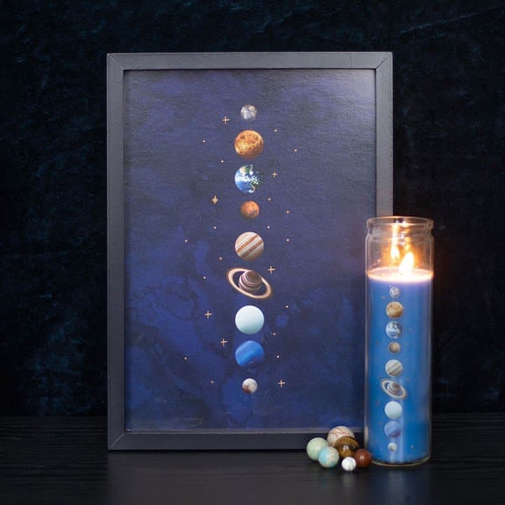Wood framed print of nine planets and gold stars on deep blue