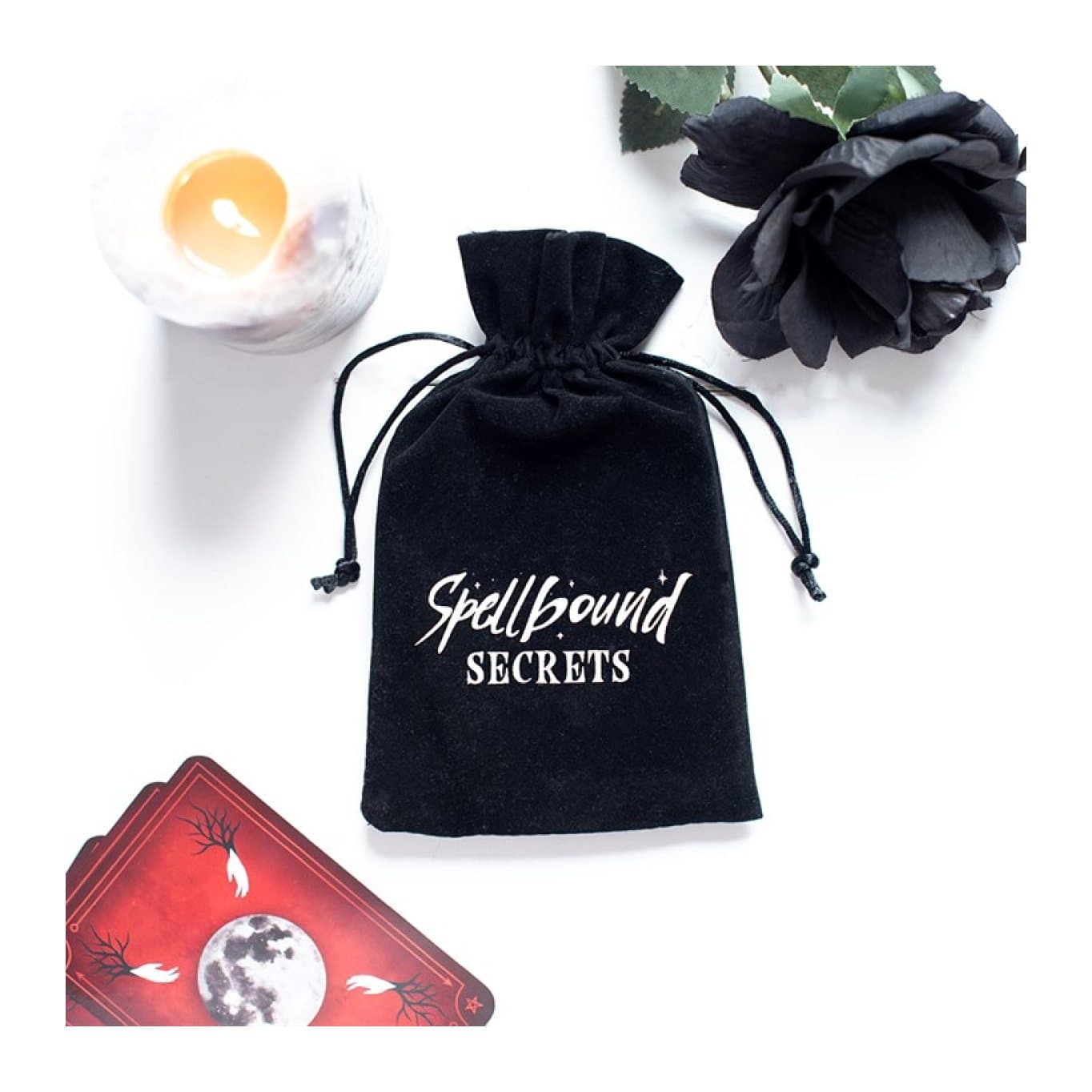 Black velvet drawstring pouch with a contrasting Spellbound Secrets logo.