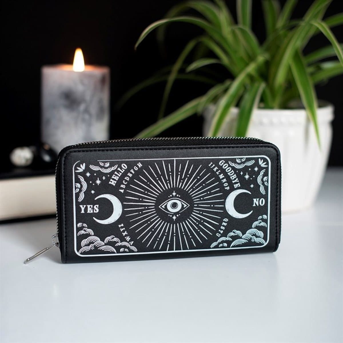 Black zippered wallet with moons, clouds and an all-seeing eye artwork