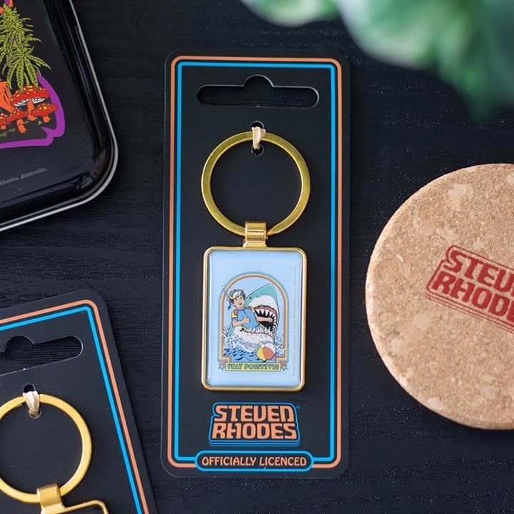 Stay Positive enamel keyring with a snorkeller and shark design