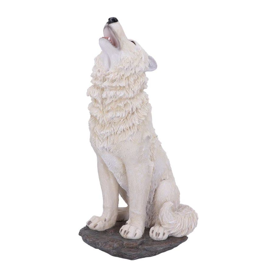 Howling white wolf figurine with orange eyes on a rocky outcrop