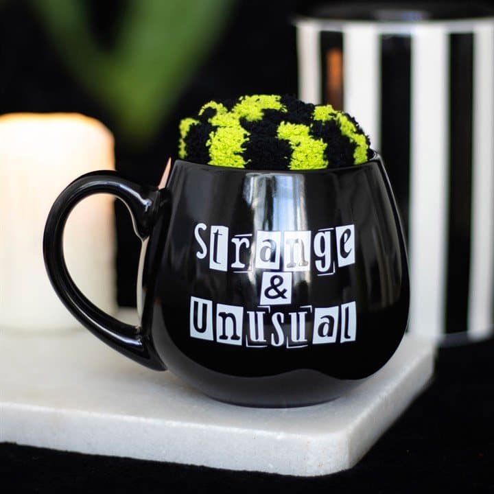 Strange and Unusual mug with stripy socks in a picture box