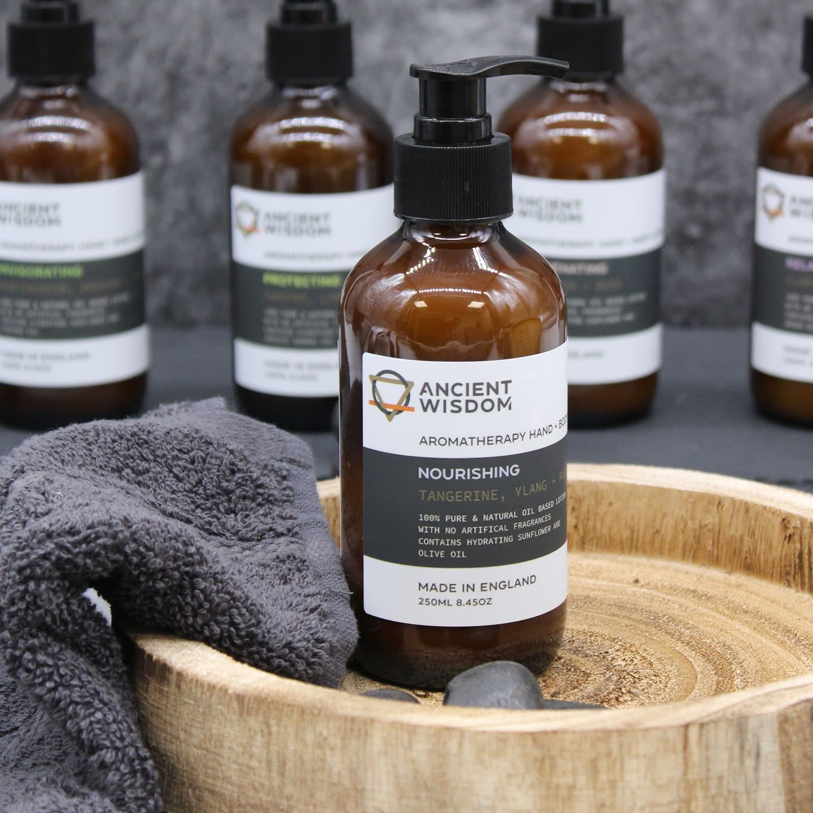Glass amber bottle of tangerine, ylang and patchouli lotion