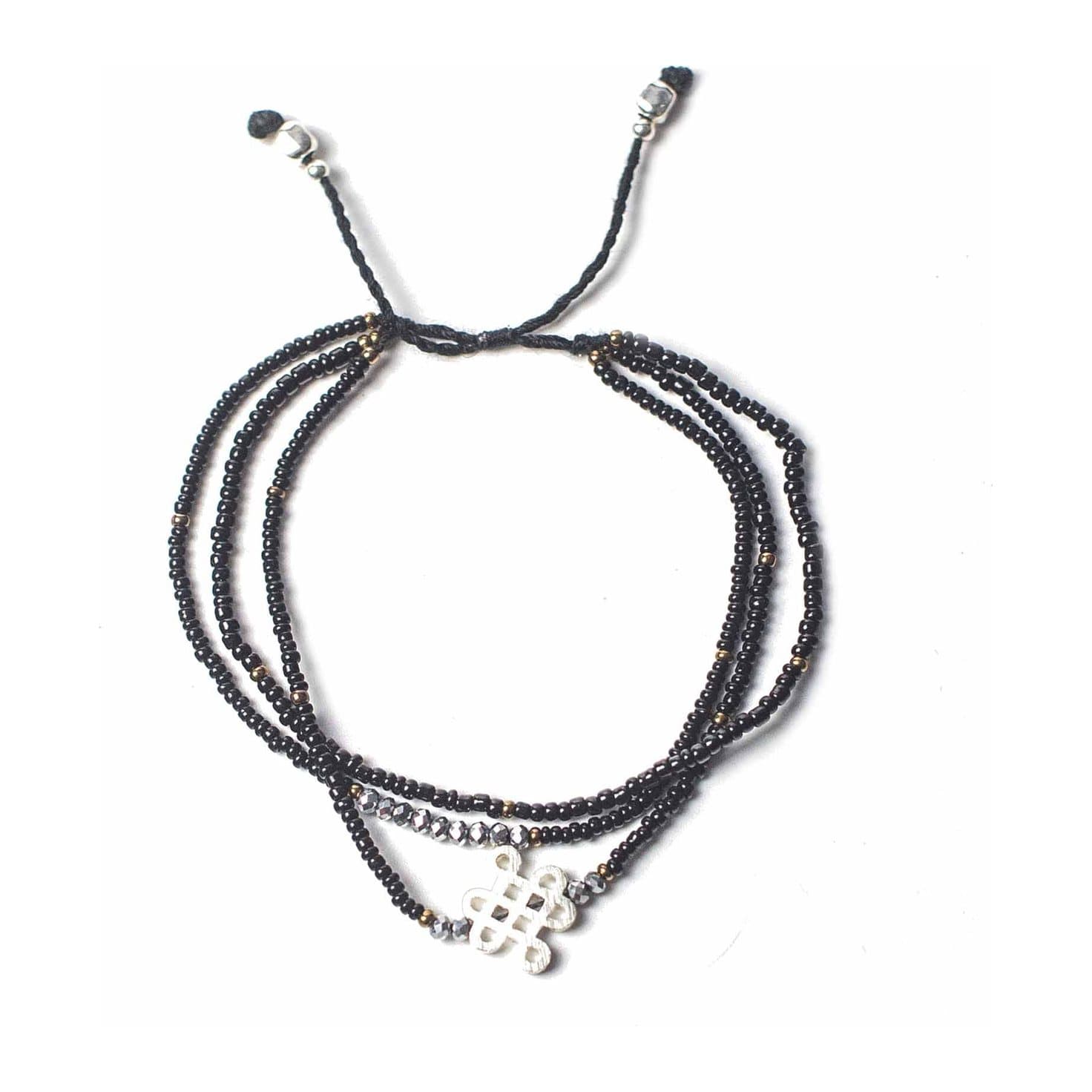 Black string bracelet with a silver symbol and Endless Knot charm