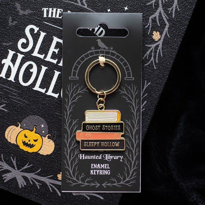 Enamel keyring shaped like a stack of eerie gothic books