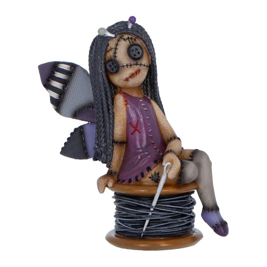 Stitchy Belle figurine: purple, dark hair, stitched wings, perched on a spool of thread.