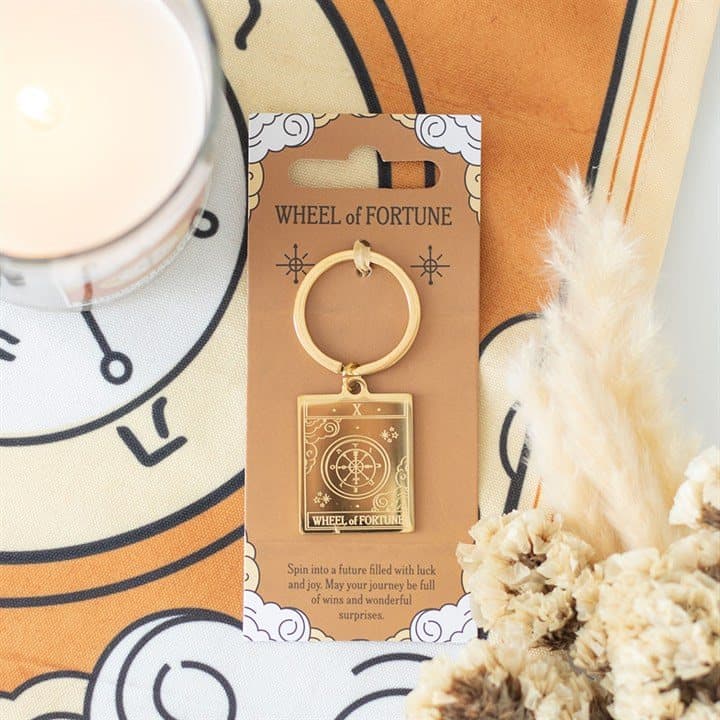 Gold-tone Wheel of Fortune tarot keyring on a matching backing card