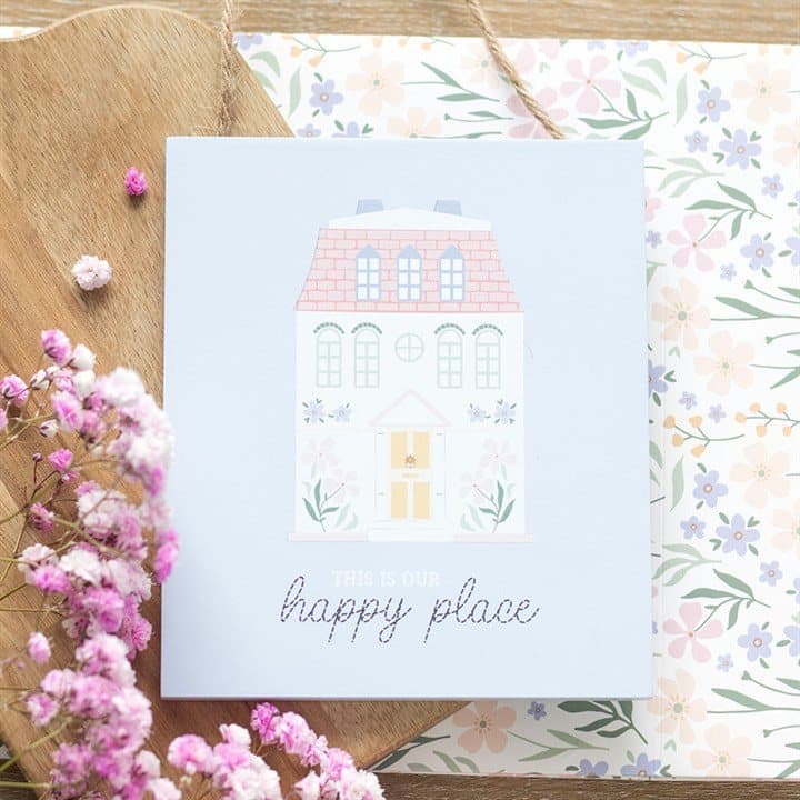 Pastel house hanging sign reading This Is Our Happy Place