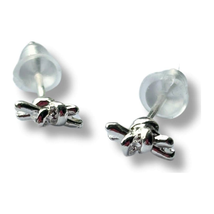 Tiny knot stud earrings in sterling silver, shown on a plain background.