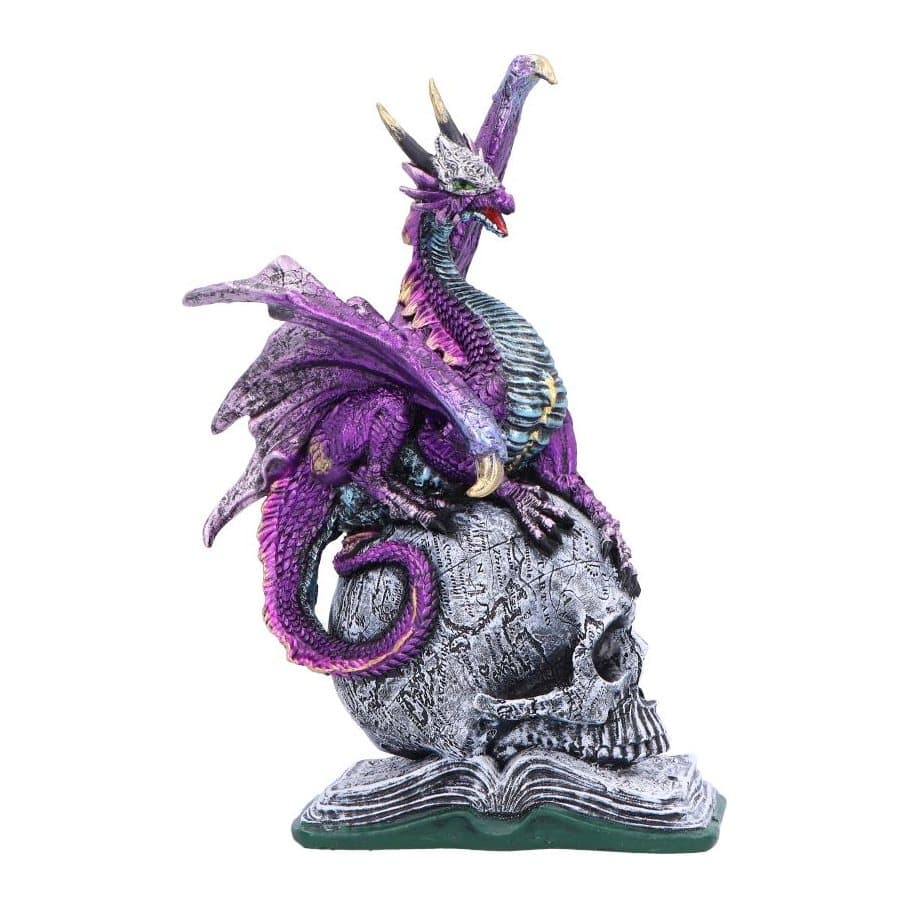Purple and silver dragon figurine perched on a skull and a book