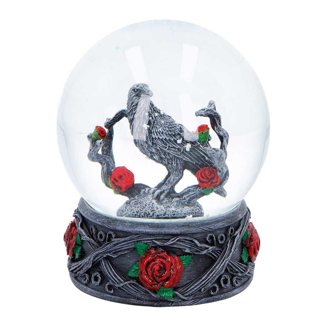 Gothic snow globe with a raven on a branch and red roses at the base