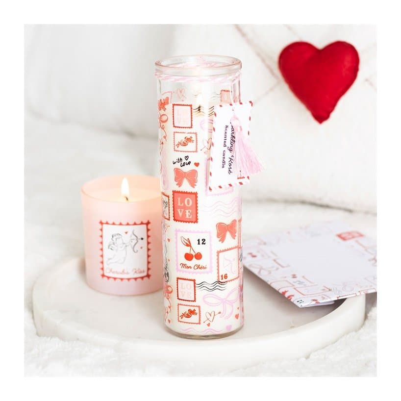 Tall glass tube candle with postage stamp print and pink tassel