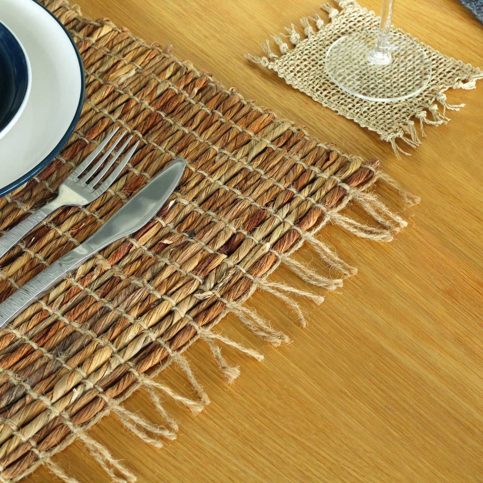 Woven water hyacinth placemat in warm Robusta tone with fringe edges