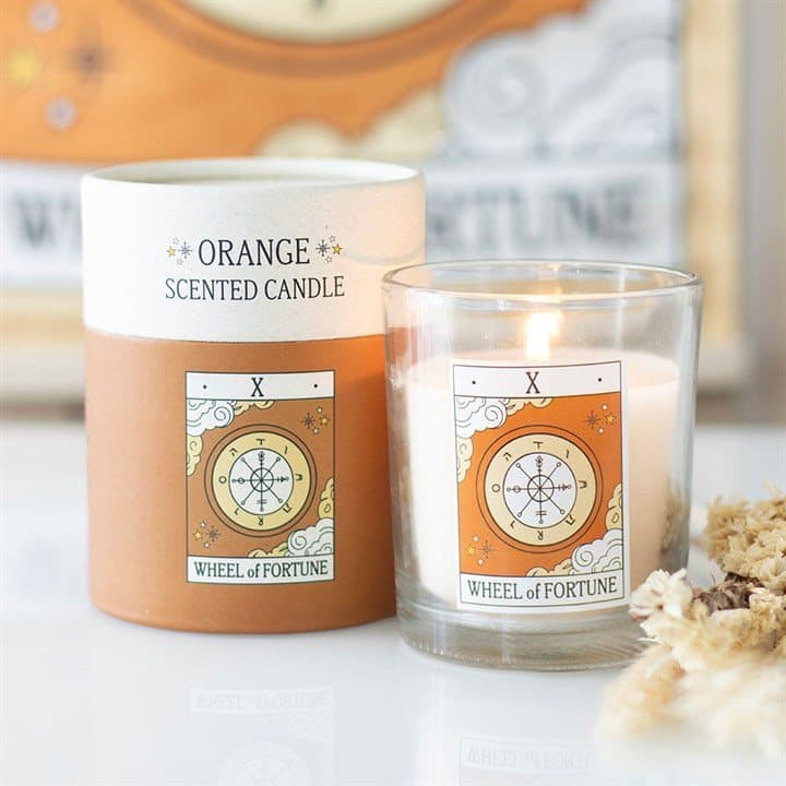 Candle with a vintage Wheel of Fortune tarot design