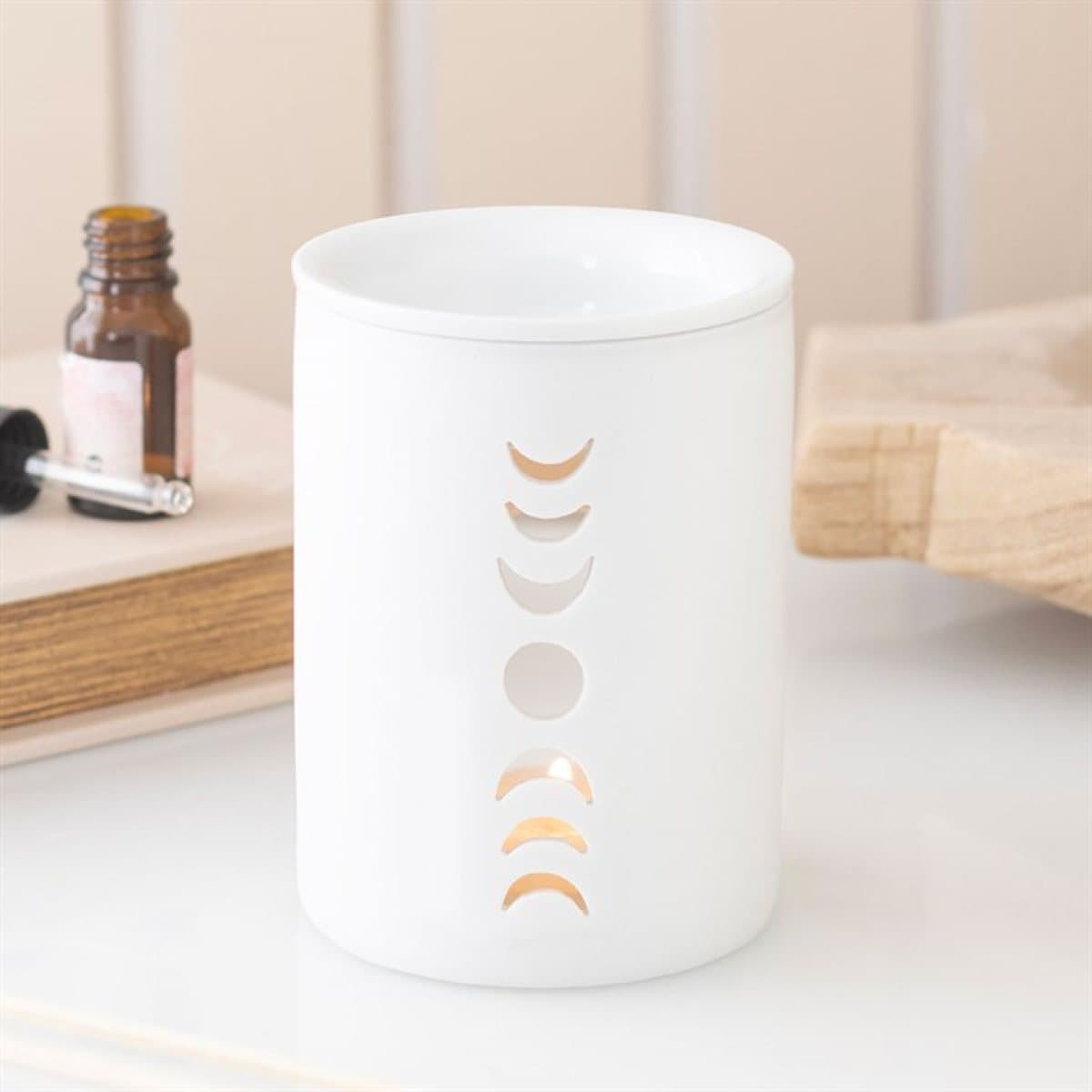 White ceramic oil burner and wax warmer with a moon phase cut out design