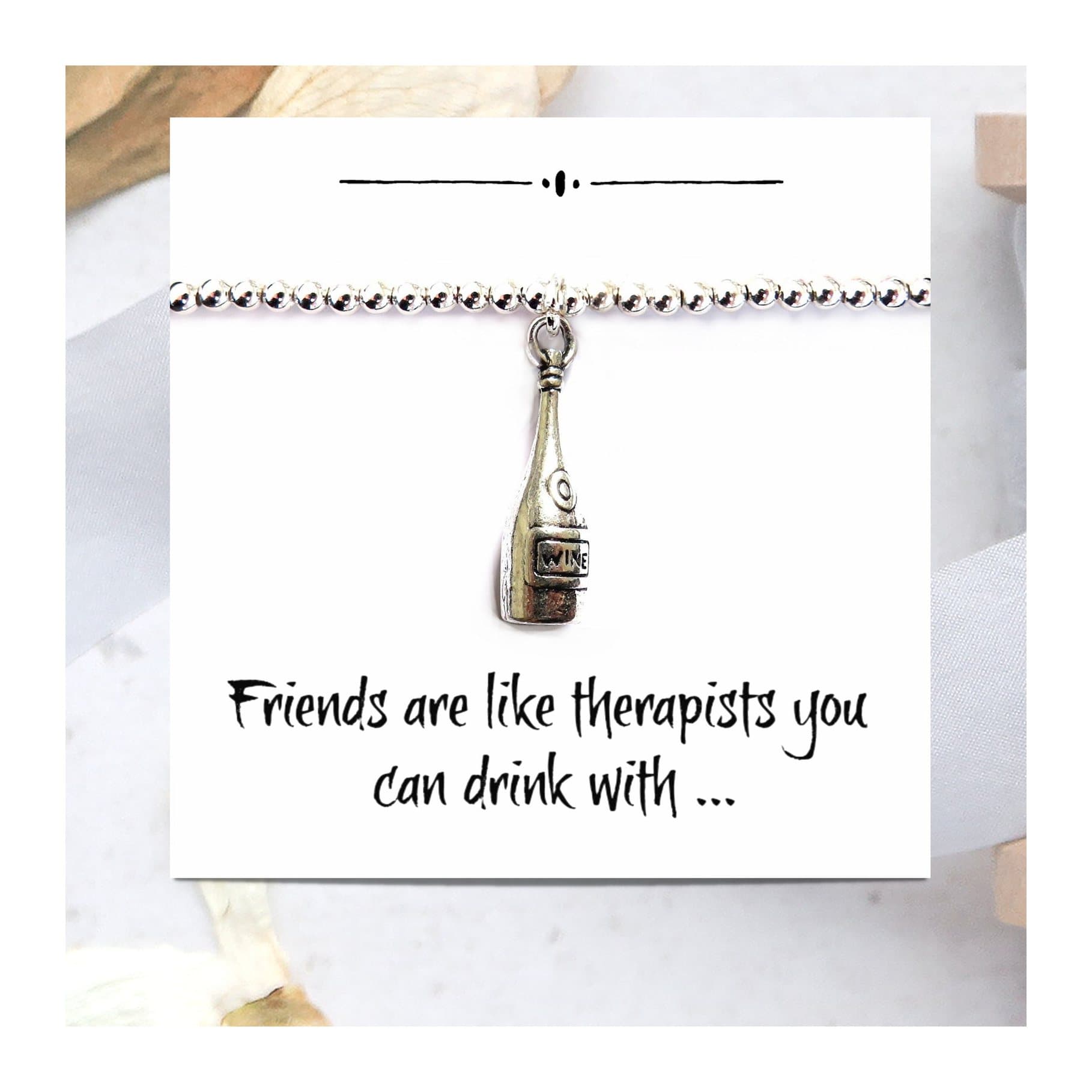 Silver plated wine bottle charm bracelet on a funny friends message card