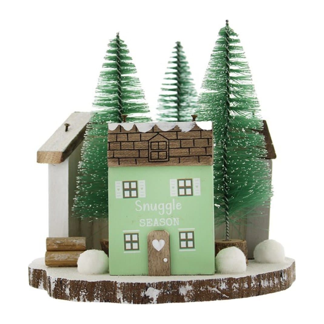 Three small wooden houses among snowy evergreen trees