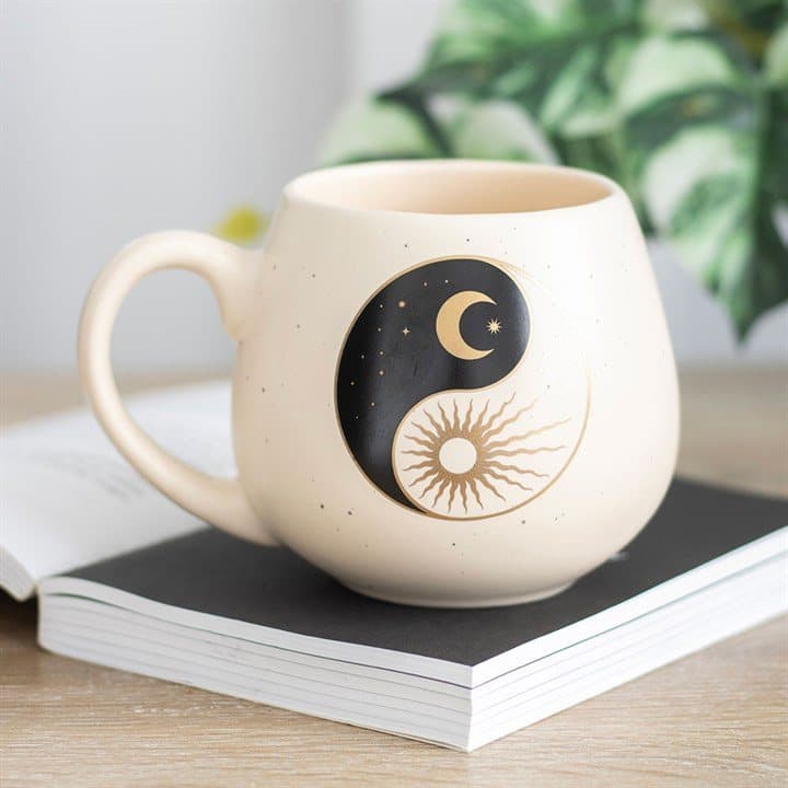 Rounded ceramic yin yang mug with a sun and crescent moon design