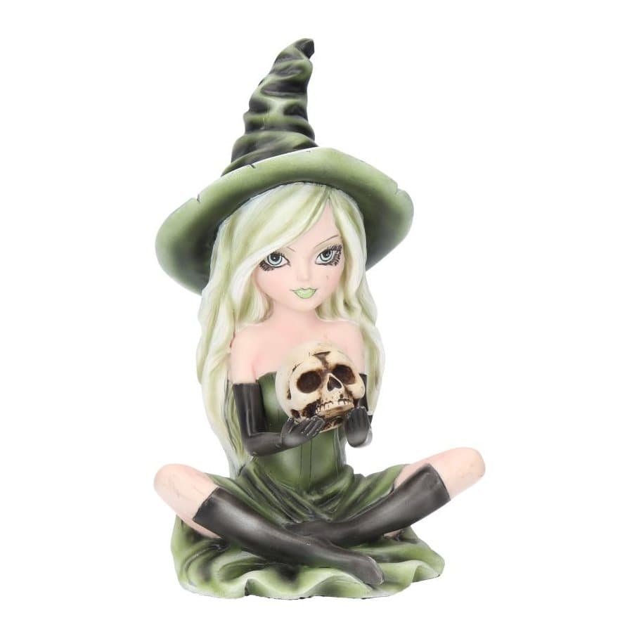 Zelda witch figurine in a green dress sitting cross-legged holding a skull